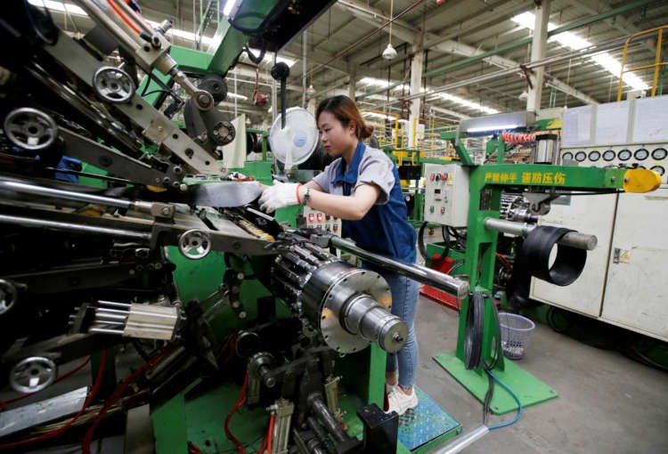 Employee working on a production line in a tyre factory during pandemic - Global Banking & Finance Review
