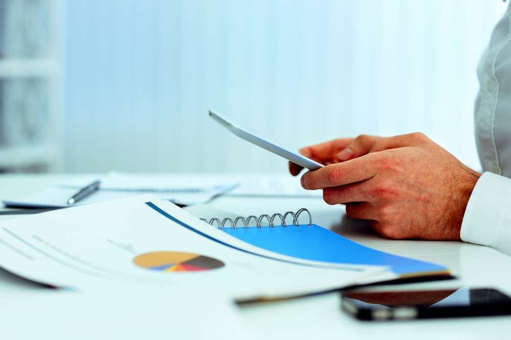 Smartphone displaying money-saving apps on screen - Global Banking & Finance Review