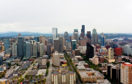 Seattle skyline featuring tall buildings, symbolizing innovation in education and law - Global Banking & Finance Review