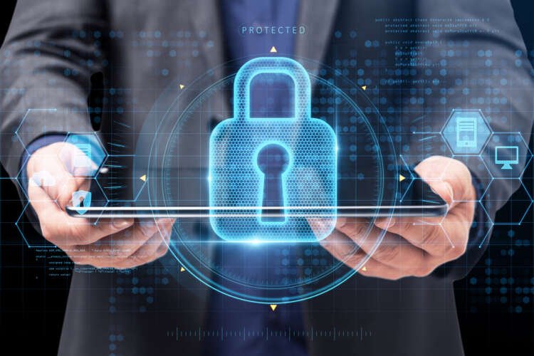 Businessman holding tablet with cybersecurity interface, representing third-party risk management - Global Banking & Finance Review