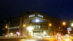 Swiss stock exchange building with financial charts, highlighting SGS-Bureau Veritas merger complications - Global Banking & Finance Review