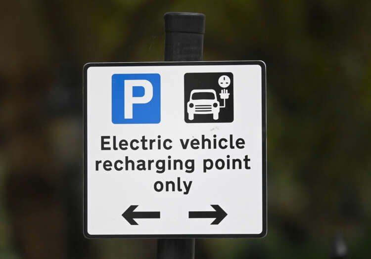 Roadside EV charging point sign in London highlighting EU electric vehicle tariffs - Global Banking & Finance Review