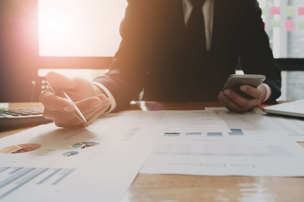 Auditors analyzing financial reports in response to COVID-19 challenges - Global Banking & Finance Review