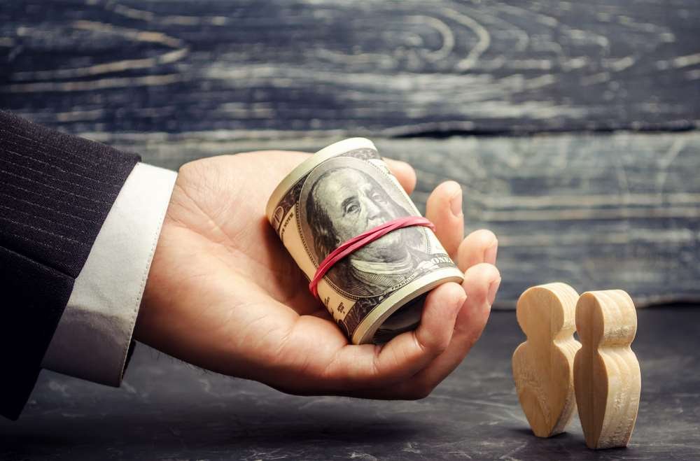 A person analyzing property investment options with charts and documents - Global Banking & Finance Review