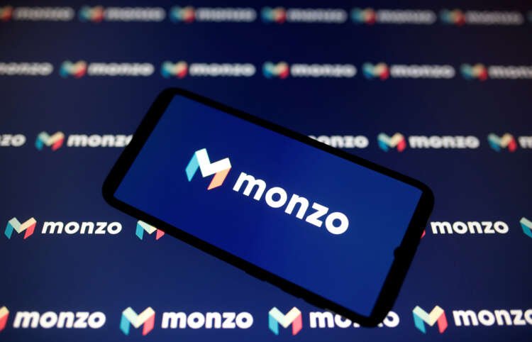 Smartphone displaying Monzo logo representing digital banking acquisition talks - Global Banking & Finance Review