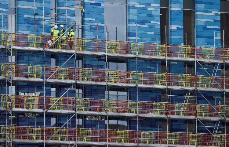 Construction workers on scaffolding highlight UK's slowing construction sector - Global Banking & Finance Review