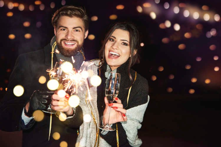 Cheerful couple celebrating new year on the city