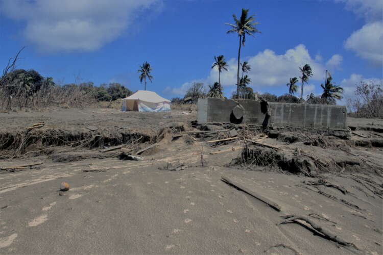 Damaged buildings and ash-covered landscape in Tonga post-volcanic eruption - Global Banking & Finance Review