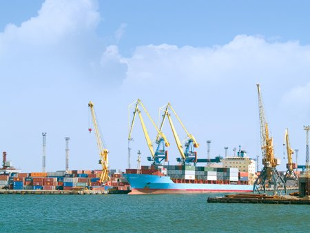 Cargo ship docked at shipyards, symbolizing trade financing challenges - Global Banking & Finance Review