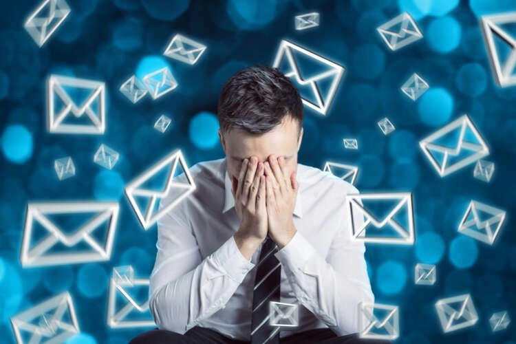 Accountants overwhelmed by email notifications, illustrating email burnout in accountancy firms - Global Banking & Finance Review