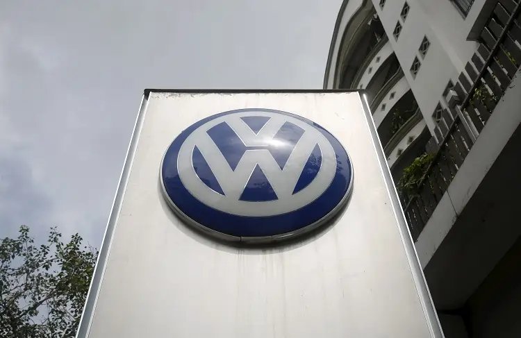 Volkswagen logo with a backdrop of Indian tax documents, highlighting allegations of import tax evasion - Global Banking & Finance Review