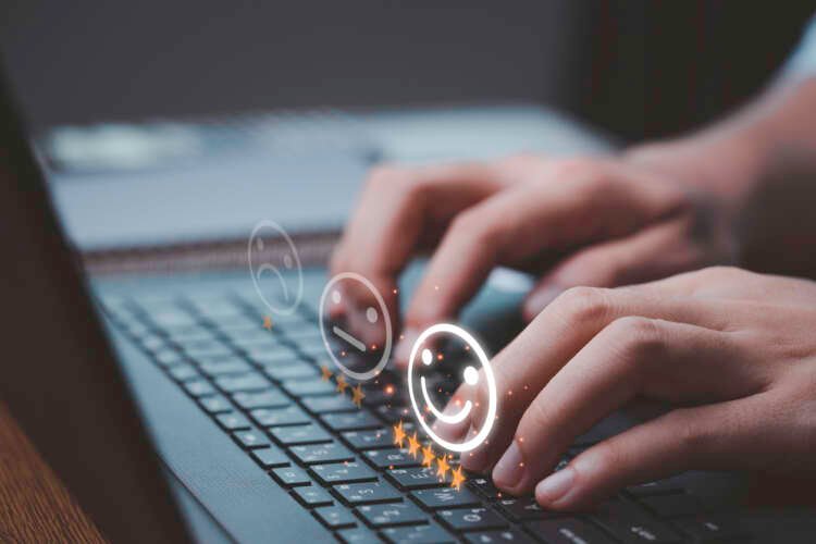 Businessman evaluating customer feedback through survey with smiley faces - Global Banking & Finance Review