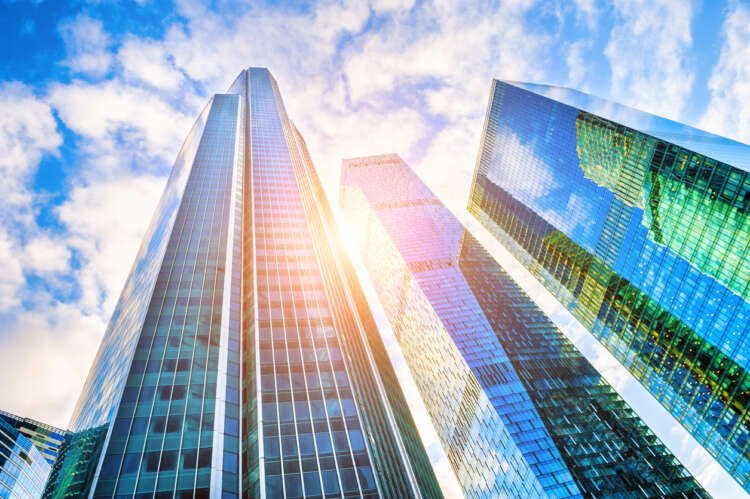 Skyline of modern glass skyscrapers representing the complexities of global finance - Global Banking & Finance Review