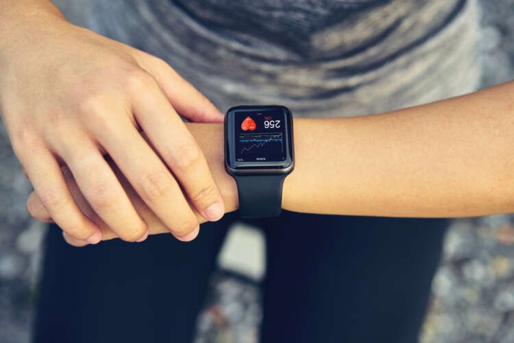 Young woman using a smartwatch for contactless payments after running - Global Banking & Finance Review