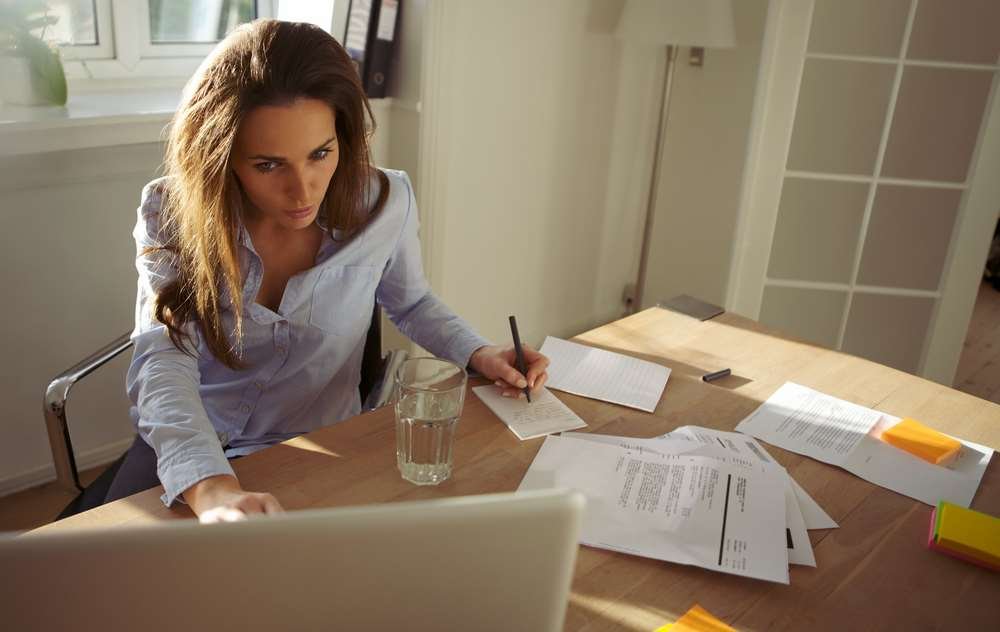 Person writing a letter of recommendation for a job or college application - Global Banking & Finance Review