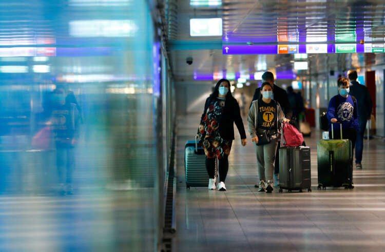 Passengers at Frankfurt Airport during peak travel season - Global Banking & Finance Review