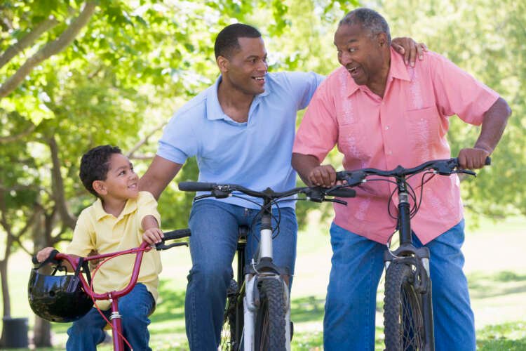 Three generations of a family biking together, symbolizing wealth transfer in finance - Global Banking & Finance Review