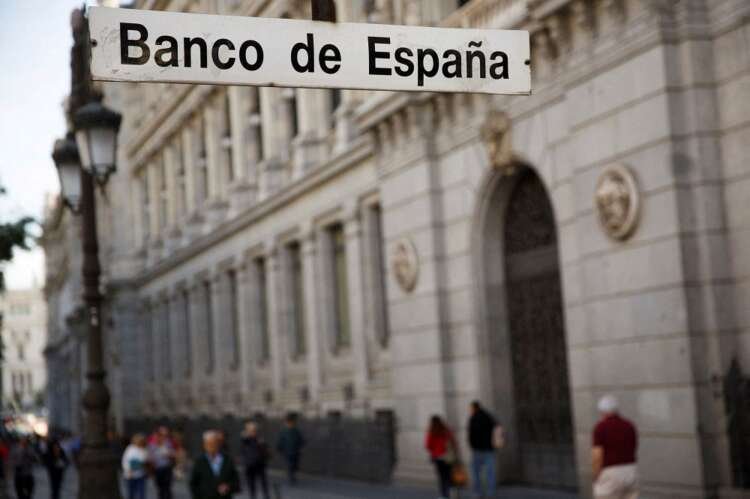 People walking past the Bank of Spain, highlighting climate policy impacts on banks - Global Banking & Finance Review