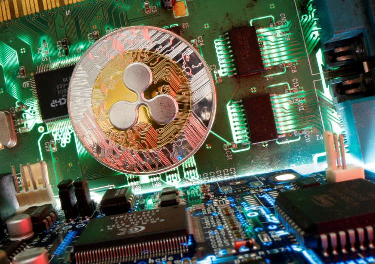 Representation of the virtual currency Ripple coin is seen on a motherboard in this picture illustration