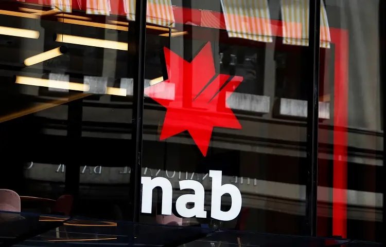 National Australia Bank logo with financial data backdrop, highlighting profit trends - Global Banking & Finance Review