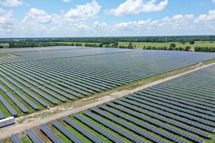 Drone view of solar panels at Impact solar facility, symbolizing ESG investment benefits - Global Banking & Finance Review