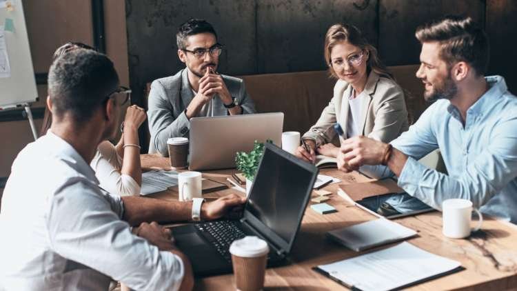 Executives discussing transformation strategies in a modern office - Global Banking & Finance Review