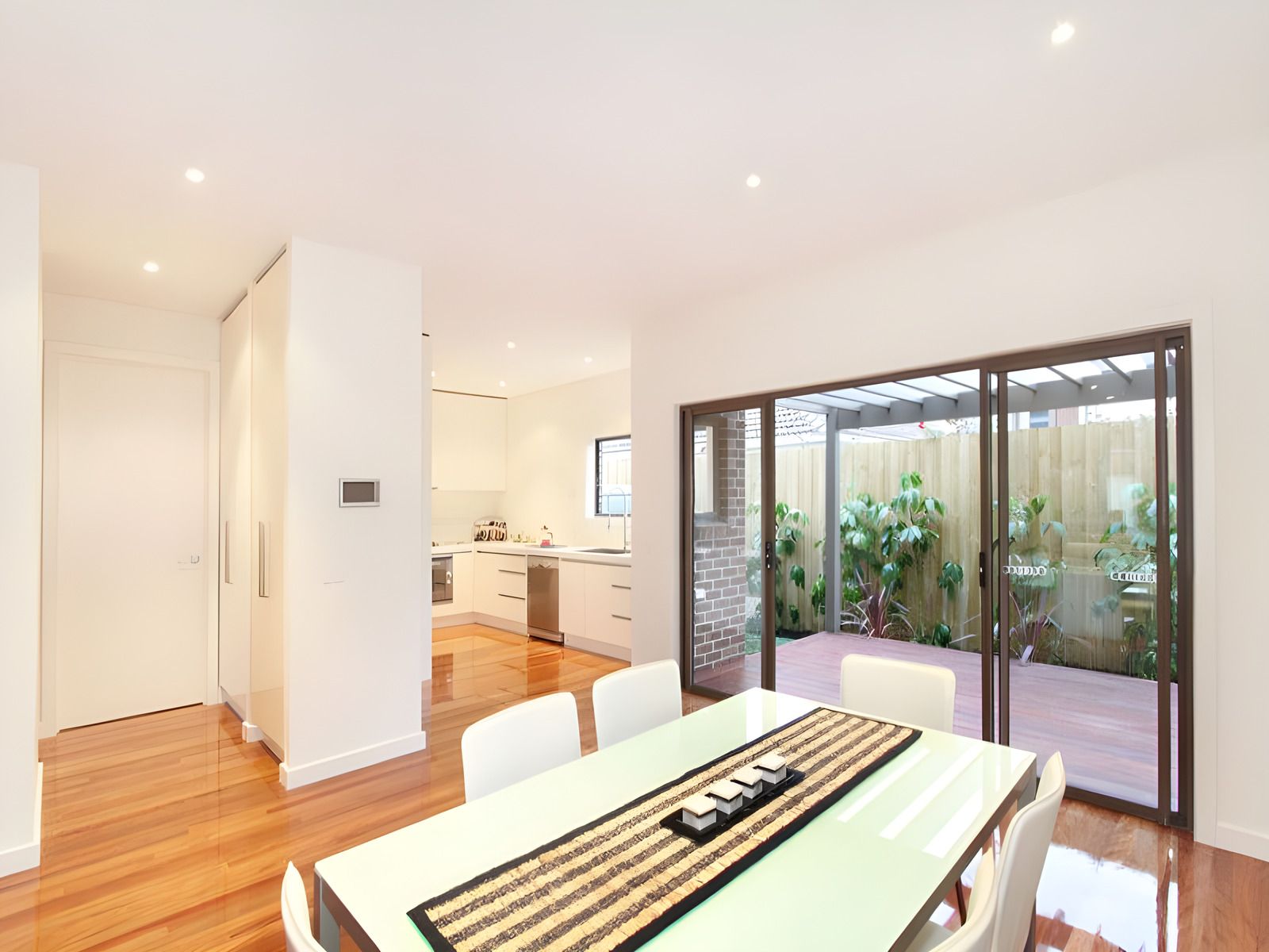 Dining room opening to the courtyard in the Hughesdale dual occupancy