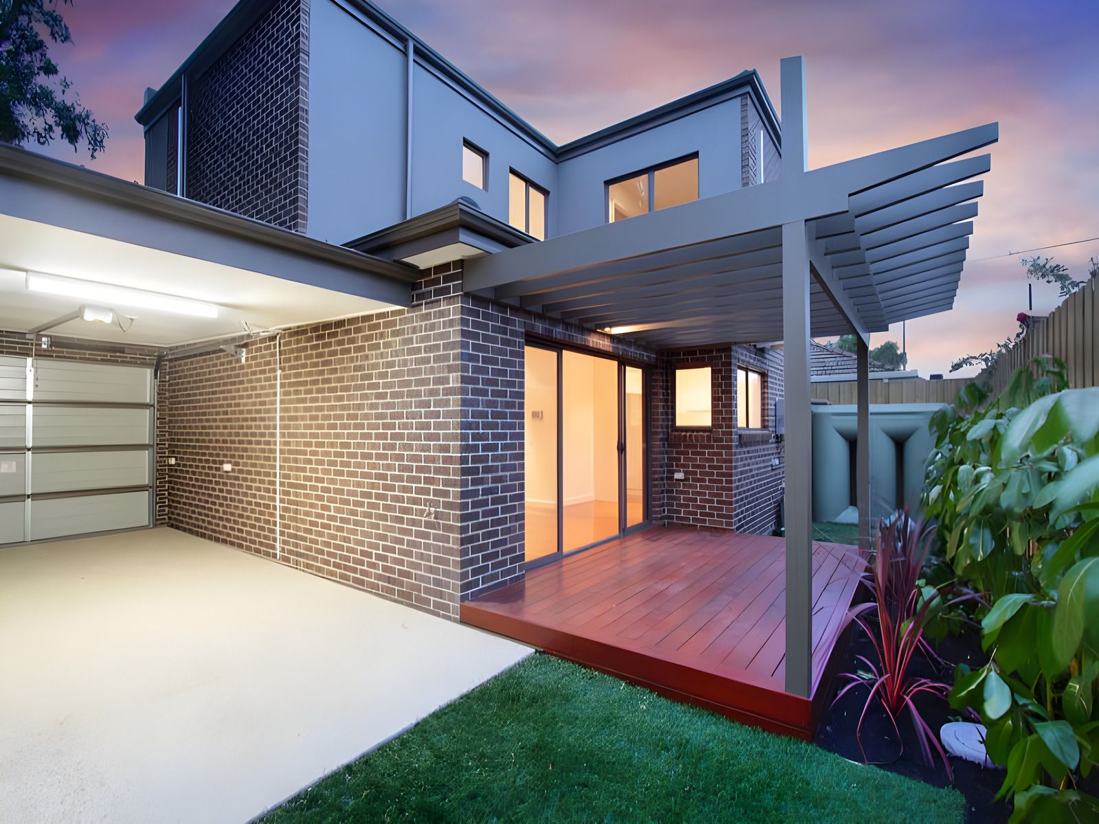 Rear courtyard of the Hughesdale dual occupancy at dusk