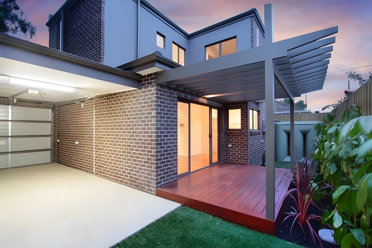Rear courtyard of the Hughesdale dual occupancy at dusk