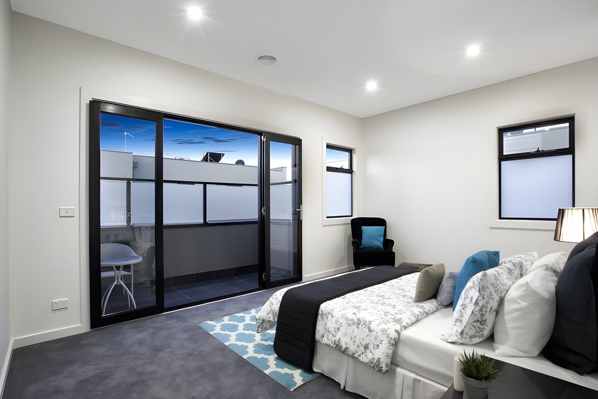 Bedroom opening to a balcony in the Glen Huntly townhouses