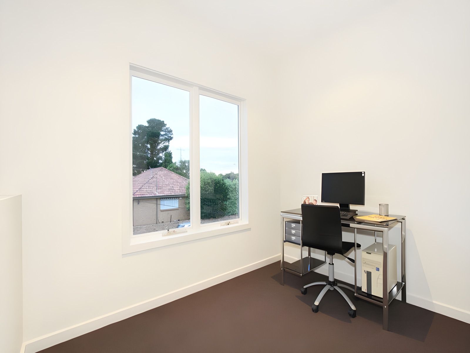 Study with a desk by the window in a dual occupancy we built