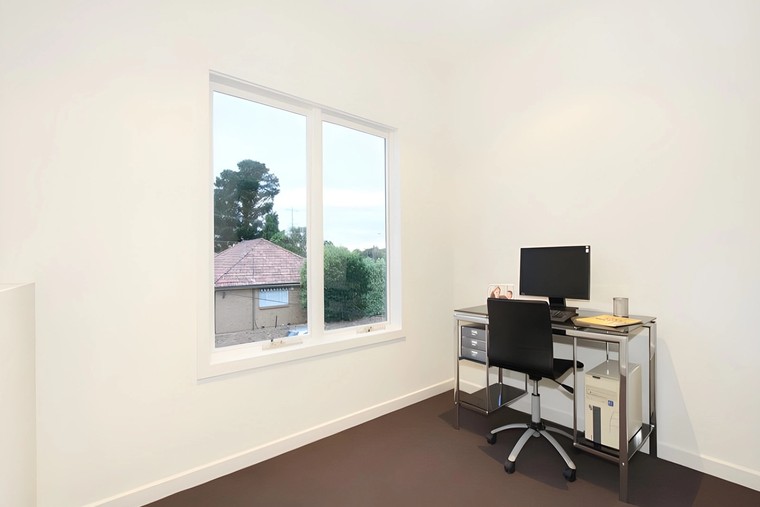 Study with a desk by the window in a dual occupancy we built