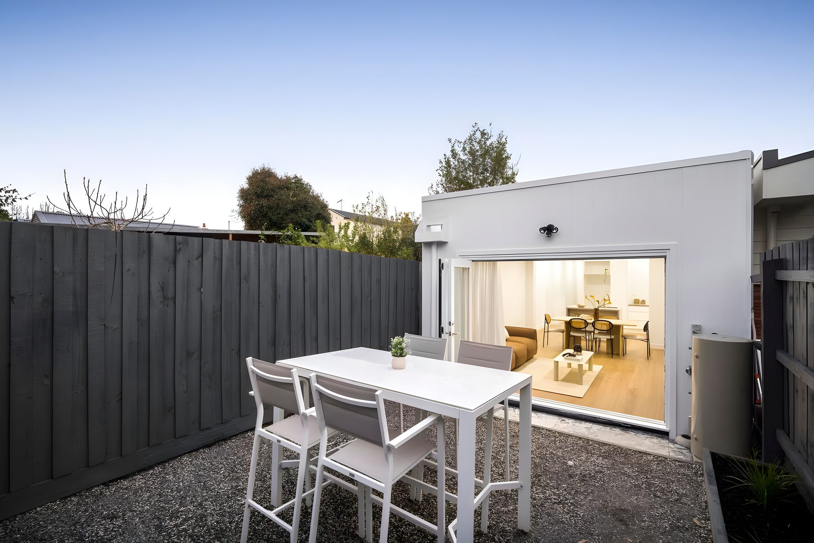 Rear of the Ascot Vale home opening to the courtyard at dusk