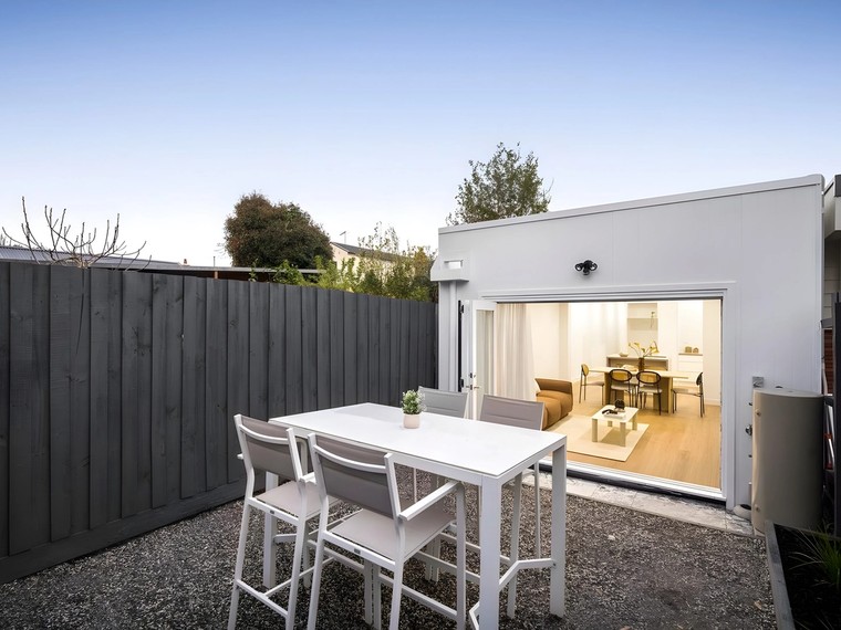Rear of the Ascot Vale home opening to the courtyard at dusk