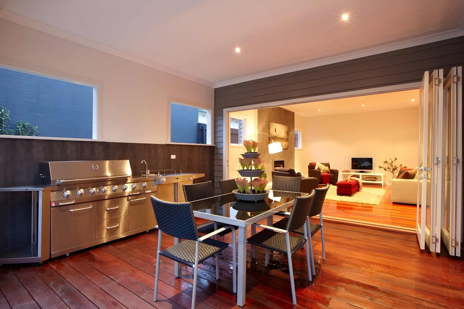 Alfresco kitchen of the Carnegie custom home at dusk