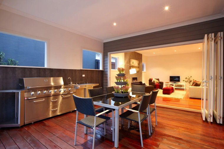 Alfresco kitchen of the Carnegie custom home at dusk