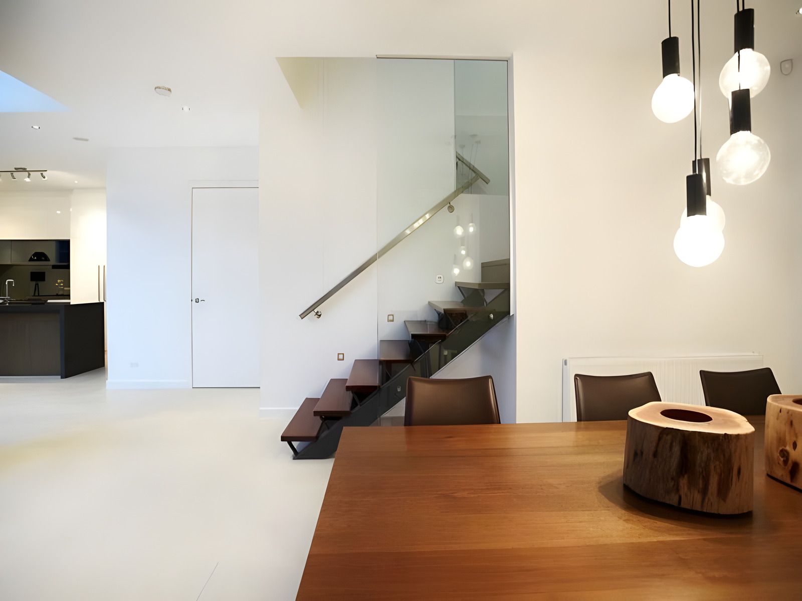 Dining table under pendant lights in the Beaumaris renovation