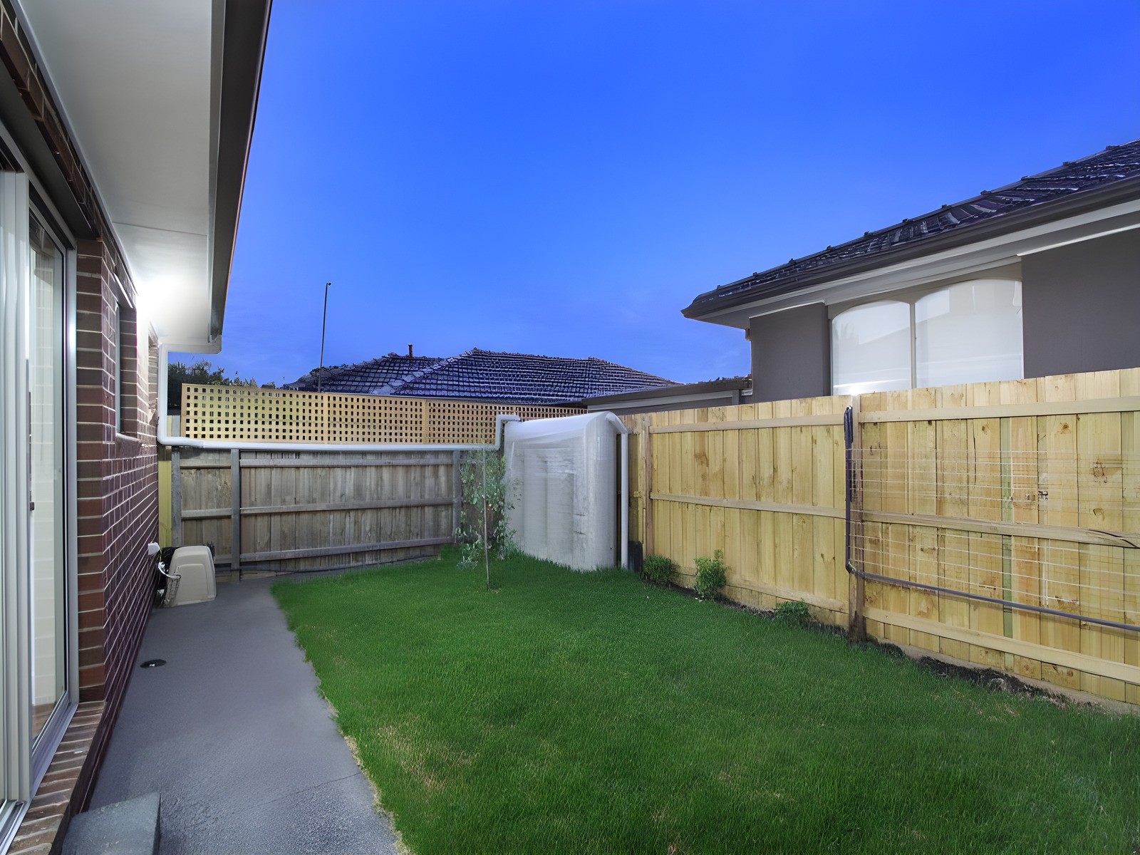 Back garden of the Oakleigh townhouses at dusk