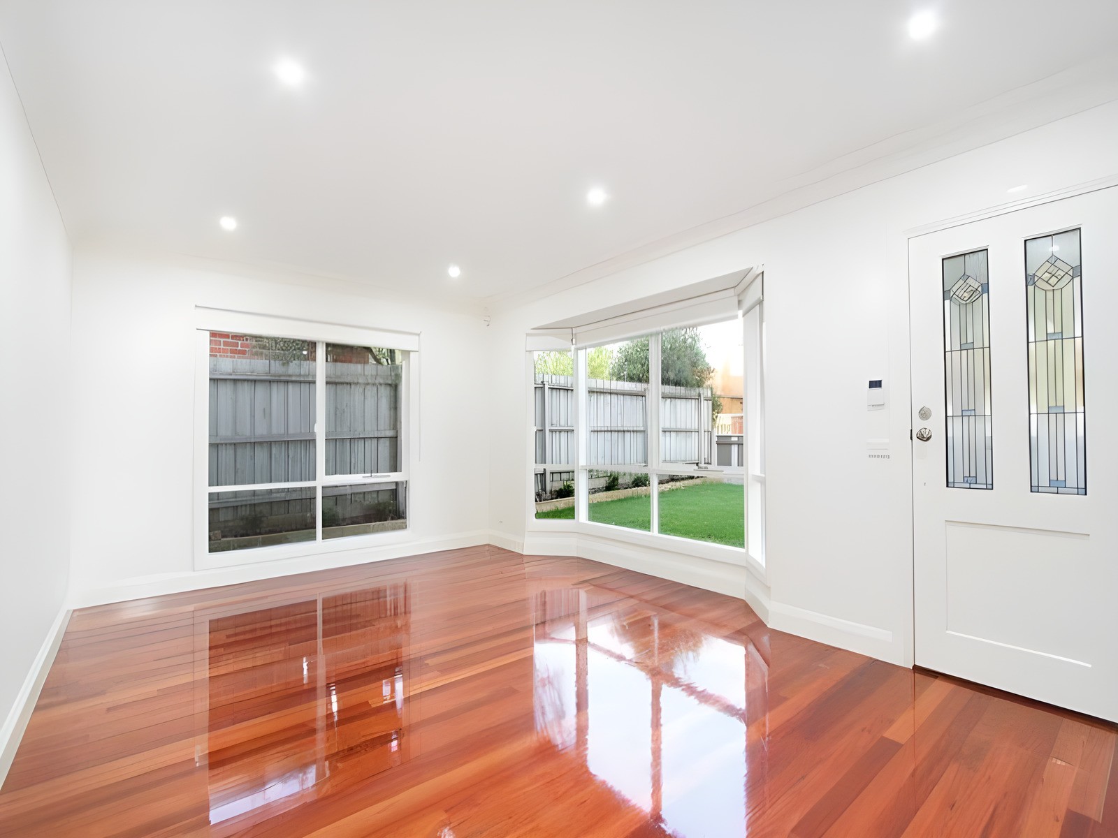 Living room with polished timber floorboards in townhouses we built