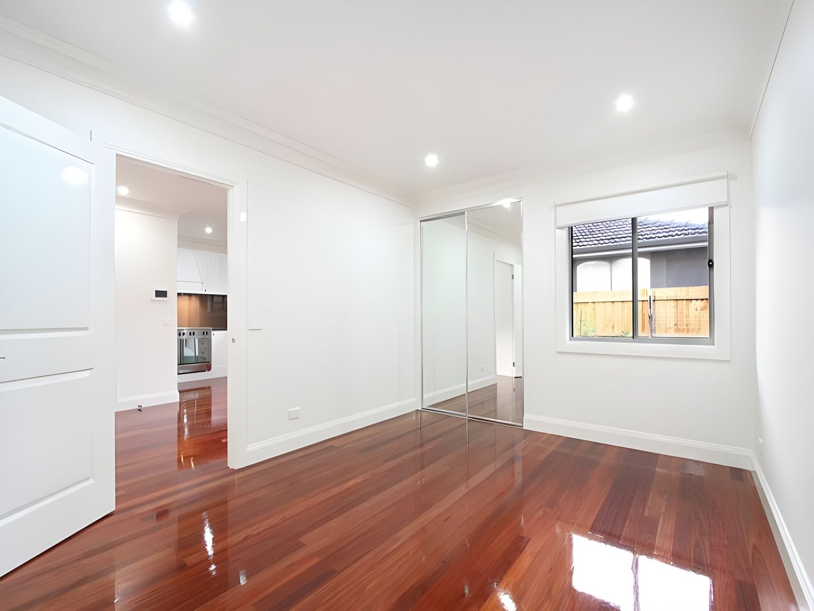 Room with a mirrored built-in robe in the Oakleigh townhouses
