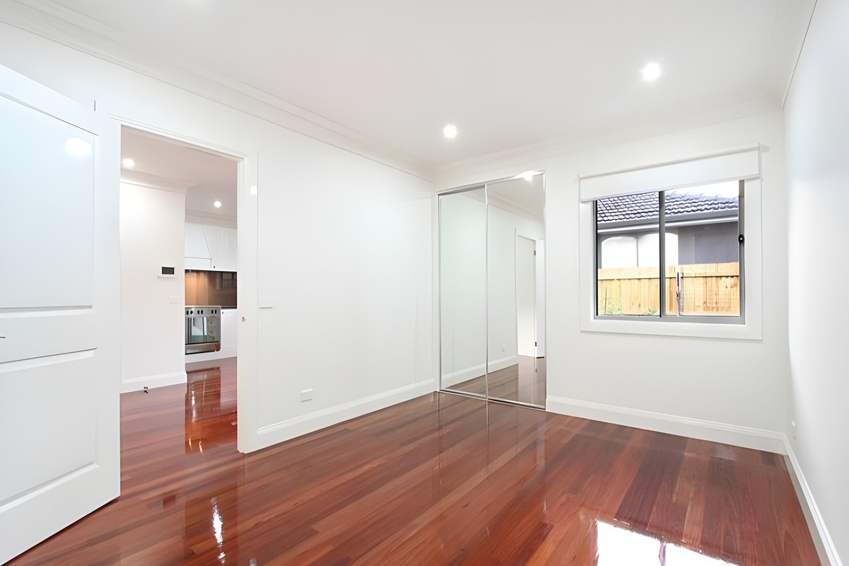 Room with a mirrored built-in robe in the Oakleigh townhouses