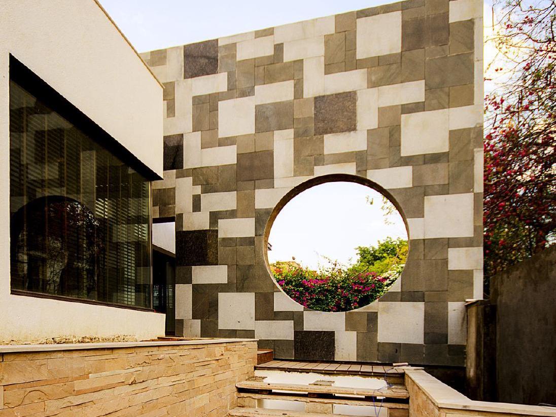 Không gian nội thất ốp đá travertine vân nâu với cửa vòm tròn