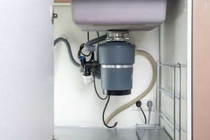 Garbage disposal underneath kitchen sink.