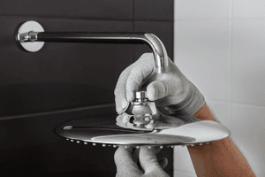 guardian plumber installing new showerhead