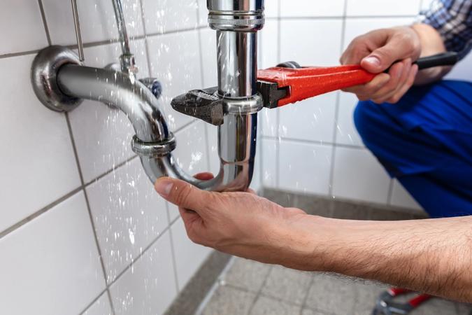 Our plumber working diligently to finish a water leak repair in Temecula, CA