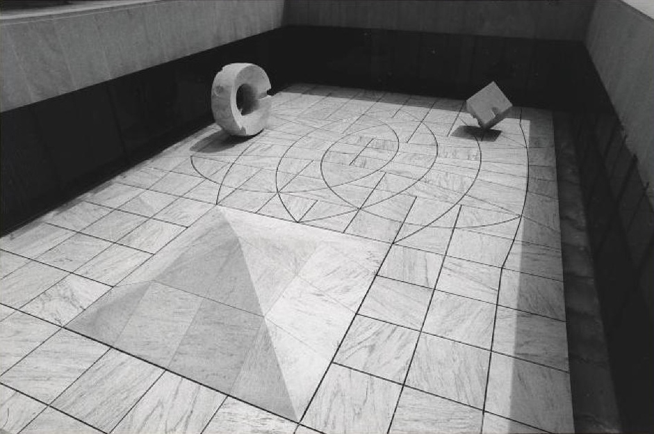 Black and white geometric art installation featuring a pyramid in a tiled floor, a standing ring, and a balanced cube. By Isamu Noguchi. Sunken Garden for Beinecke Rare Book and Manuscript Library