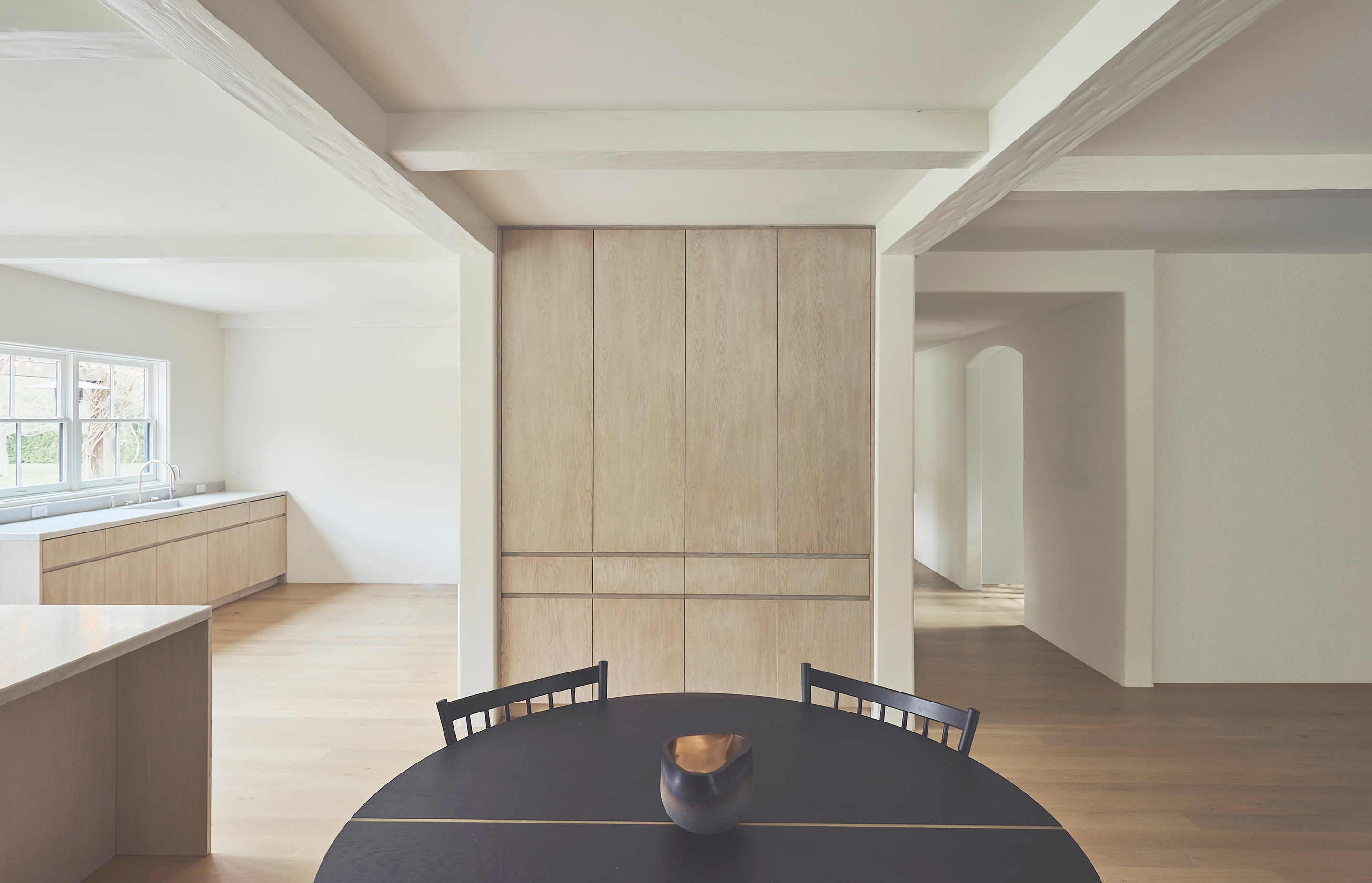 there is a table and chairs in the middle of the room .