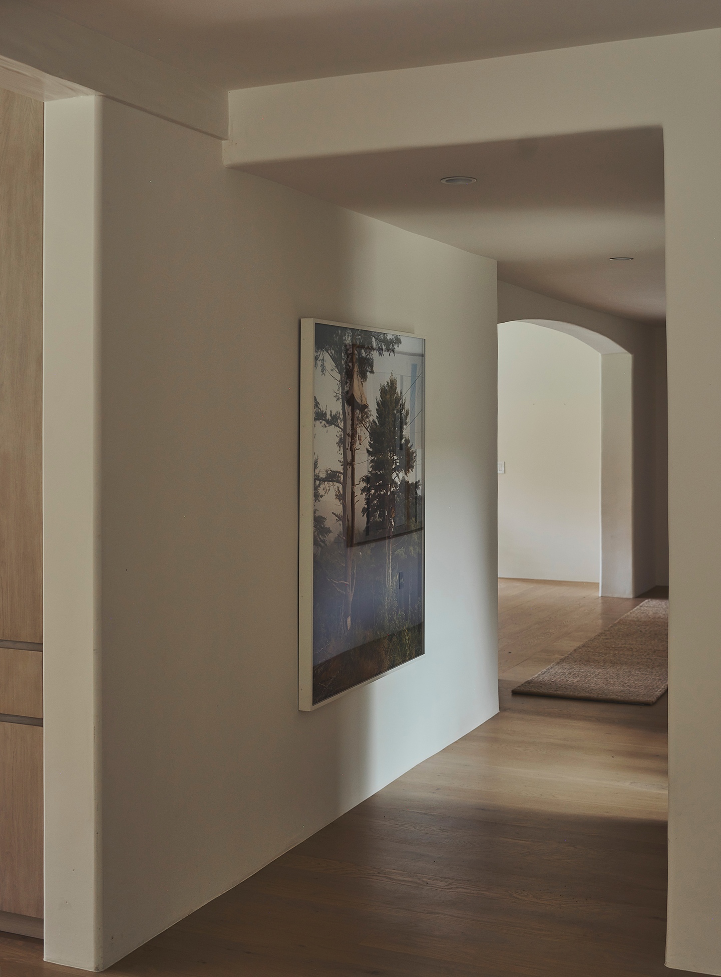 a painting is hanging on a wall in a hallway