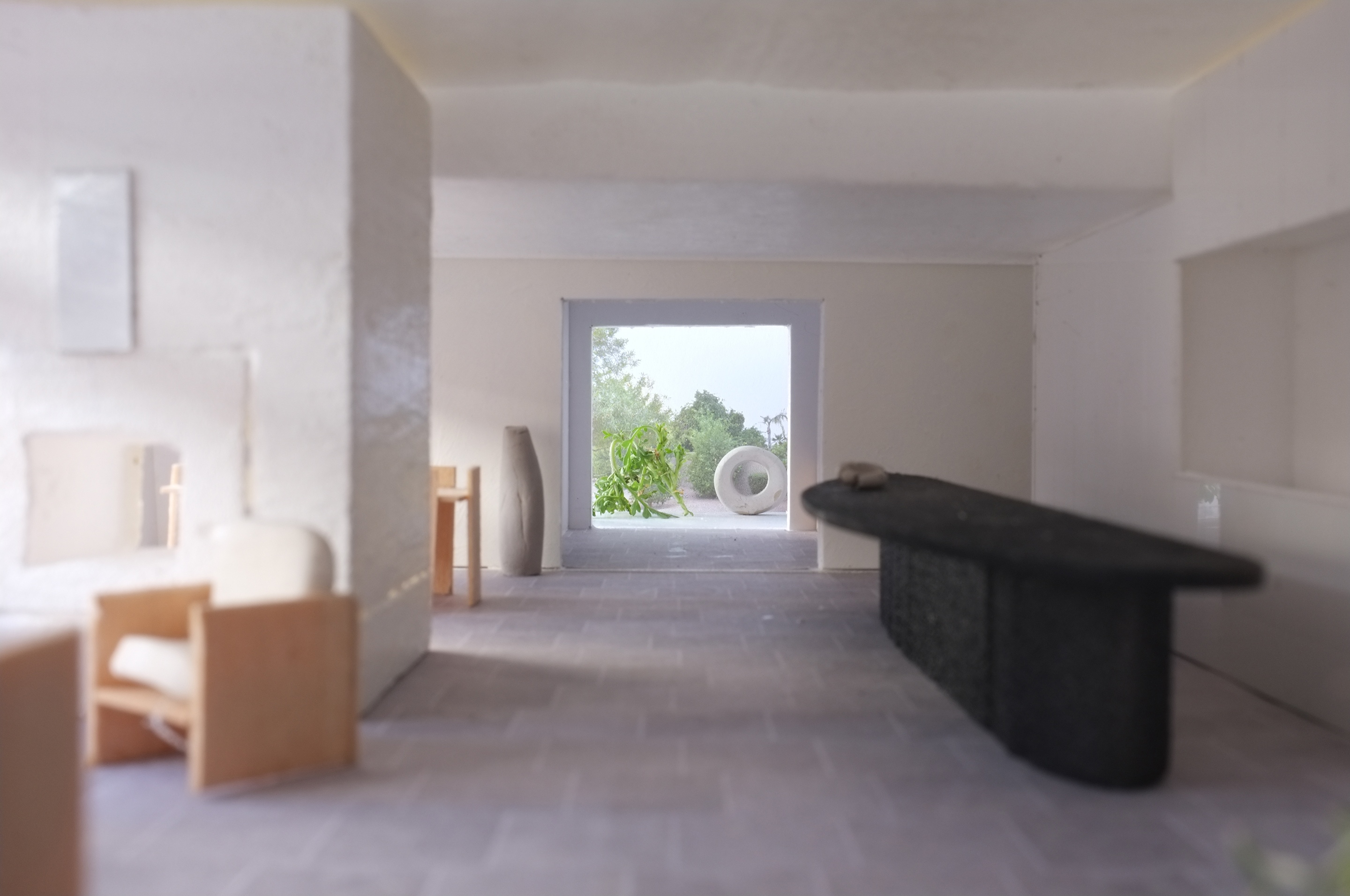 a model of a living room with a table and chairs .