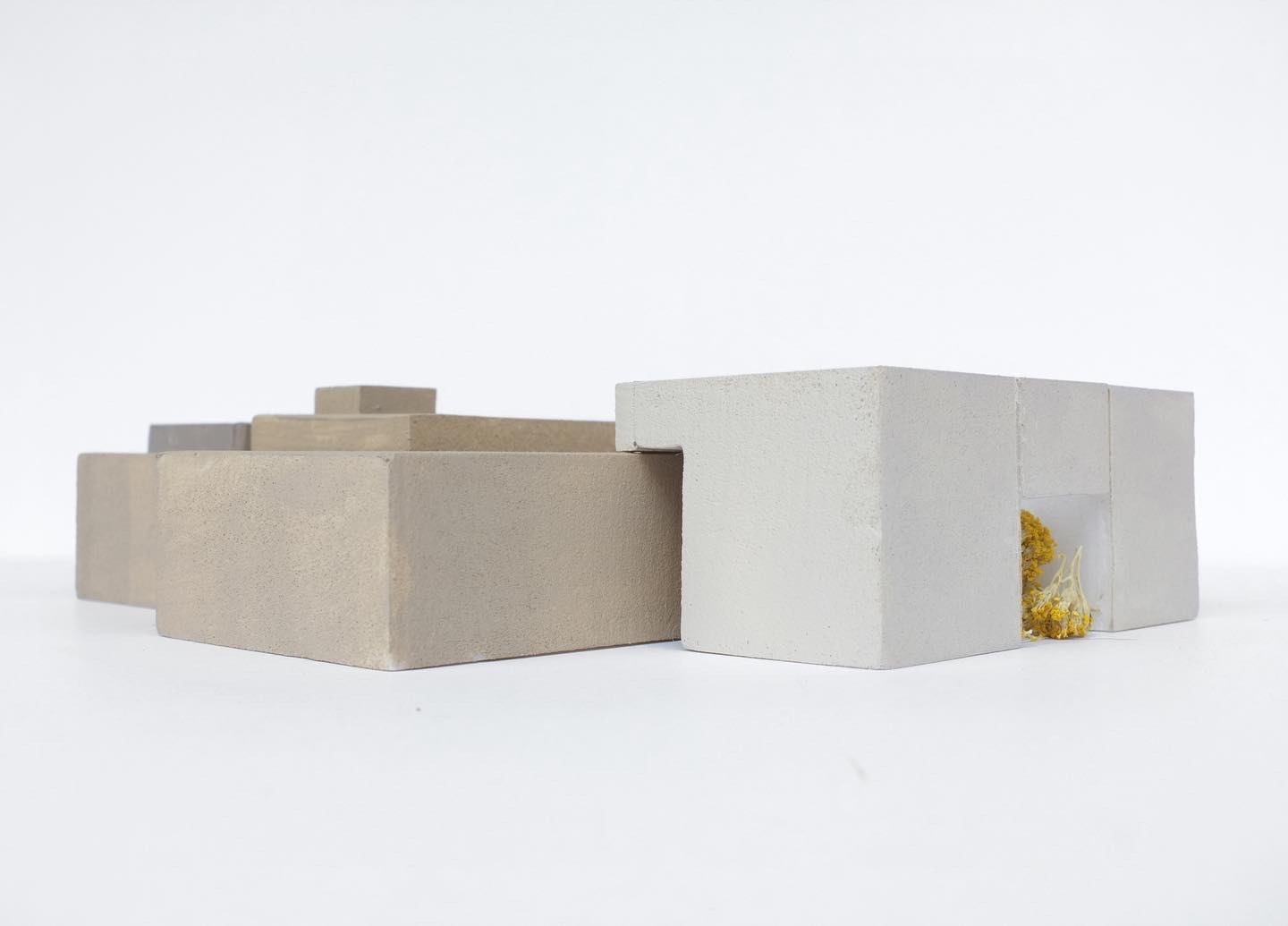 a model of a house made of concrete blocks on a white surface .